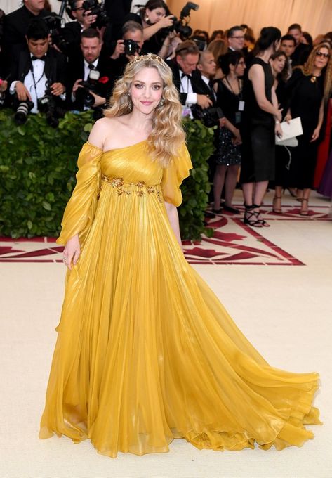 Amanda Seyfried arrived at the 2018 Met Gala in a flowing gown fit for a glowing goddess. The 32-year-old actress adhered to the religious "Heavenly Bodies" theme by wearing a romantic Renaissance-style gown and tiara by Prada. Thomas Sadoski, Vestidos Versace, Flowing Gown, Met Gala Outfits, Met Gala Dresses, Gala Outfit, Heavenly Bodies, Moschino Dress, Red Carpets