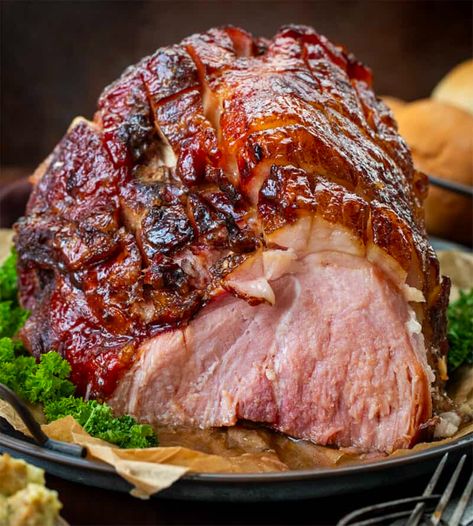 Brown Sugar Glazed Ham is a bone-in ham topped and roasted with a sweet, tangy, and spiced brown sugar glaze that creates a caramelized coating. It is so easy to make and perfect for your Christmas dinner menu! It is so delicious in all of your leftover ham recipes! Bone In Ham, Brown Sugar Glazed Ham, Ham Shank, Egg Bakes, Brown Sugar Ham, Lunch Sandwiches, Ham Glaze Brown Sugar, Ham Recipes Baked, Homestead Recipes