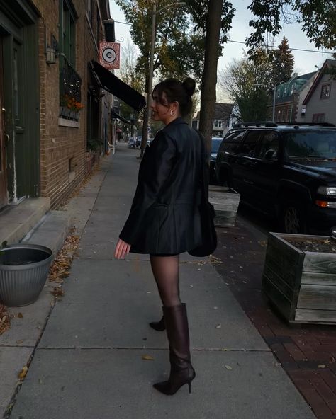 Knee High Brown Boots Black Leather Jacket Brown Boots, Leather Jacket And Tights Outfit, Oversized Knee High Boots, Tall Heel Boots Outfit, Brown Boots Black Tights, Tall Black Heeled Boots Outfit, Tall Heeled Boots Outfit, Tall Black Boots Outfit Work, Black Leather Knee High Boots Outfit