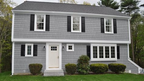 A house with gray paint, white trim and black shutters. Light Gray Siding White Trim, Grey Vinyl Siding House Black Shutters, Gray Houses With Black Shutters, Light Grey House With Black Shutters, Gray Siding With Shutters, Grey White And Black Exterior Homes, Vinyl Siding Color Ideas, Light Grey Siding House, Light Gray House With Black Trim