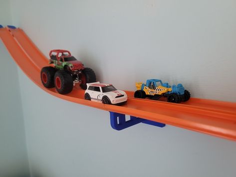 Diy Hot Wheels Display Ideas, Hotwheels Rooms, Hot Wheels Set Up, Cars Room Decor Boys, Monster Truck Race Track Diy, Hot Wheel Tracks Ideas, Hot Wheel Bedrooms Ideas, Monster Jam Christmas Tree, Racecar Bedroom Toddler