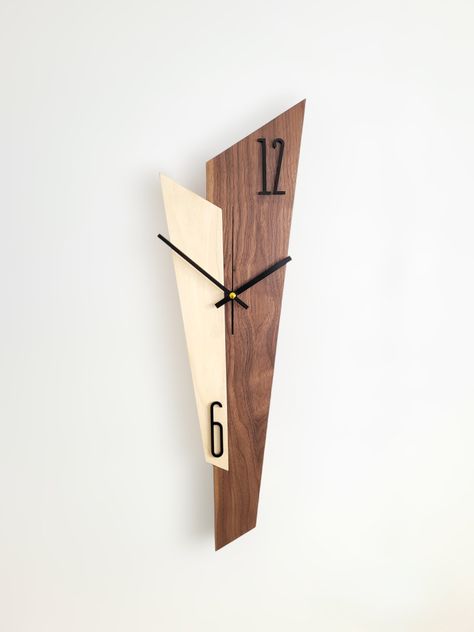 Sizes: 58x18x2cm This unique and special wall clock is not just a clock, but an elegant decoration for your home. Elevate your home décor with our elegant wall clock, crafted from premium walnut and white poplar. This minimalist masterpiece seamlessly blends into any style, adding a touch of sophistication and refined taste. This product is handmade in a small workshop in Hungary, where the master creates each piece with his own hands with love and careful attention. This is how time, nature and design will be in a unique harmony that lives on and tells without words all the experience-filled past that this tree has experienced. Clean and minimalist design: Our wall clock boasts a sleek and uncluttered aesthetic, perfectly complementing modern, contemporary, and Scandinavian interiors. Hig Diy Wood Clocks, Wood Clocks Handmade, Wooden Clock Ideas, Diy Clock Ideas, Wall Clock Design Modern, Modern Wall Clock Design, White Poplar, Wood Clock Design, Walnut Wall