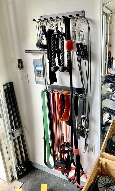 Keep your gym equipment organized and tidy with this sturdy storage rack. With multiple shelves and hooks, you can easily store your yoga mats, resistance bands, jump ropes, and more. #fitness #gym #homegym #workout https://www.theworldaccordingtome.org/fitness-health/1713761_at-home-gym-essentials-home-gym-on-a-budget/?home-gym-tour-with-andee-layne Tiny Home Gym, Home Gym On A Budget, Home Gym Storage, Gym Organizer, Home Gym Essentials, Dream Gym, Small Home Gym, Home Gym Garage, Mini Gym