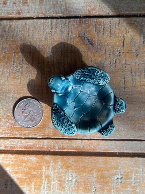 Elevate your home decor with this handcrafted 2.5"x2" turtle ring dish, featuring a stunning peacock glaze. Perfect for holding your rings, earrings, and other small trinkets, this unique ceramic dish showcases a charming turtle design with an iridescent finish that shimmers in blue-greens. Each piece is hand crafted and glazed, making it a beautiful and functional addition to your decor. Ideal as a gift for turtle lovers or as a special treat for yourself. Approximate dimension:  Width: 2.5" Length: 2." Pleae Note: As each piece is handmade, slight variations and unique marks may occur, making your turtle trinket truly unique. Small Turtle, Turtle Ring, Small Turtles, Trinket Holder, Small Trinkets, Turtle Design, Glaze Ceramics, Unique Ceramics, Ceramic Dishes