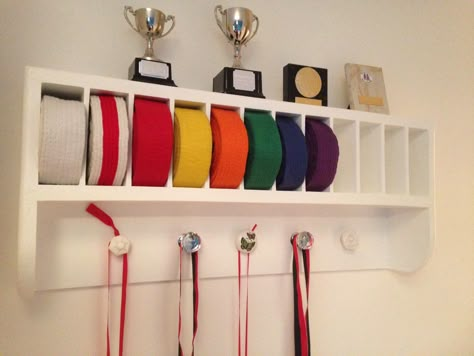 Martial Arts belt rack. Great storage & display for medals, belts & trophies. Kung fu, karate, judo etc. Made by RonJohn Home Improvements. Taekwondo Display, Jiu Jitsu Belt Display, Martial Arts Belt Rack, Martial Arts Belt Holder, Taekwondo Belt Display, Brazilian Jiu Jitsu Belts, Karate Belt Display, Martial Arts Belt Display, Martial Arts Belt