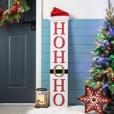 Crafted from textured MDF, this Christmas sign features a lambswool hat on the top of the sign. On one side is a smiling snowman with a Welcome printed on its body. The other side is the Santa belt with HoHoHo. Stylish design with classical red and black, it brings a traditional and classic feel to your holiday home. | The Holiday Aisle® Junno Reversible Wooden Christmas Snowman Porch Sign 42.5 H x 8.25 W x 2.25 D in black / brown / red / whiteWood in Black / Red | 42.5" H X 8.25" W X 2.25" D | Christmas Signs Wood Front Porches, Santa Belt, Christmas Wooden Signs, Wooden Porch, Wooden Welcome Signs, Front Porch Signs, Christmas Signs Wood, Holiday Signs, Porch Sign