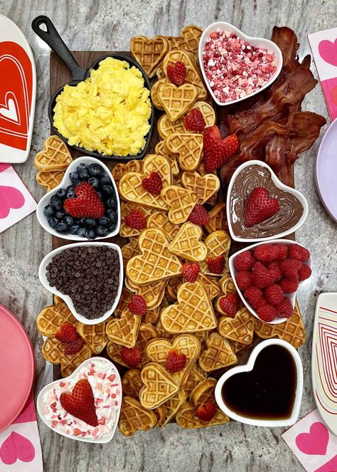 Valentine Family Breakfast, Valentine’s Day Waffle Bar, Heart Waffle Board, Heart Breakfast Ideas, Galentines Brunch Waffle Bar, Kids Valentine Breakfast Ideas, Mini Heart Waffles, Easy Valentine Breakfast Ideas, Breakfast Ideas For Valentines Day