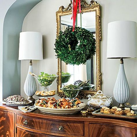 Simple with such great impact. Hanging a Christmas wreath over a mirror adds such great impact Wreath Over Mirror, Wreath On Mirror, Branch Wreaths, Christmas Wreaths For Windows, Muebles Shabby Chic, Christmas Buffet, Suspension Design, Buffet Table, Southern Living