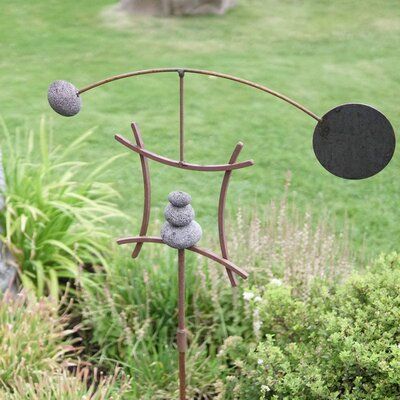 Simple lines with sweeping arches create a relaxing visual display in Aura life’s zen garden kinetic wind sculpture. The calming, Asian-inspired wind spinner is ideal for outdoor Japanese gardens, rock gardens, patios, lawns, and more. | Arlmont & Co. Eiko Kinetic Fairy Garden Metal, Size 50.0 H x 25.0 W x 3.0 D in | Wayfair Kinetic Wind Art, Kinetic Wind Sculpture, Kinetic Wind Spinners, Rock Cairn, Florida Landscape, Garden Spinners, Metal Wind Spinners, Wind Art, Wind Vane