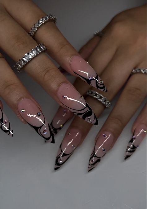 Stiletto gel x nails with pink base and black swirl French tip with crystals scattered Black Almond Acrylic Nails Design, Almond Nails Designs Medium Length, Black Acrylic Nails Black Women, Black Designed Nails, Trendy Nail Inspo Winter, Gothic Style Nails, Concert Nails Black, Clear Nails With Black Designs, Over The Top Nail Designs