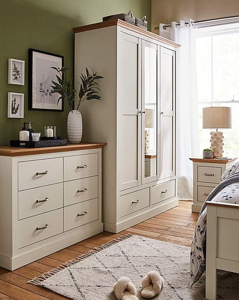 Part of the Julipa Brand. Bring an elegant country-style charm into your bedroom with the Ashford bedroom range. This package includes the 2 x 2 Drawer Bedside, 6 Drawer Chest and the 3 Door Wardrobe. Featuring oak-effect tops which is perfectly contrasted by the wood-effect frame and a chunky plinth, this range is perfect to add a warm and homely feel to your bedroom. Doors feature classic panelling, drawers are sat on easy-glide runners that provide plenty of storage for all your bedroom essen Bedroom Furniture With Storage, Neutral Bedroom Wardrobe Ideas, Bedroom Decor Drawers, Freestanding Bedroom Furniture, Wardrobe And Chest Of Drawers Bedroom, Alvine Kvist Bedroom Ideas, Bedroom Inspirations With Wardrobe, Cream Wood Bedroom, White And Wood Bedroom Ideas