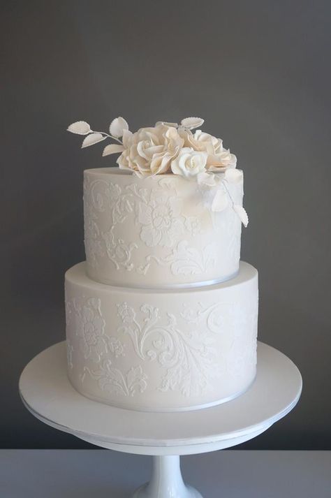 Ivory cake with white stenciling and sugar flowers . Cake Envy Melbourne White On White Stencil Cake, Lace Stencil Wedding Cake, Wedding Cake With Stencil Design, Wedding Cake Stencil Patterns, Wedding Cake Lace Design, Stencil Wedding Cake Designs, Stenciled Wedding Cakes, White Stencil Cake, Stencil Wedding Cake