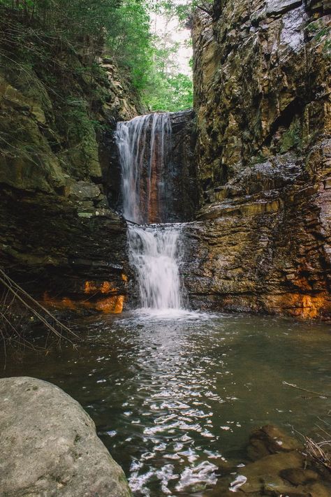 A waterfall makes its way between two rock walls, carving out a wide path for the water to take. Two levels of falling water, orange and brown rocks everywhere. A beautiful peaceful landscape photo. Tennessee Mountains Aesthetic, Copperhill Tennessee, Tennessee Waterfalls, Mountains Aesthetic, Fall Break, Knoxville Tennessee, Morgan Wallen, East Tennessee, Summer Bucket Lists