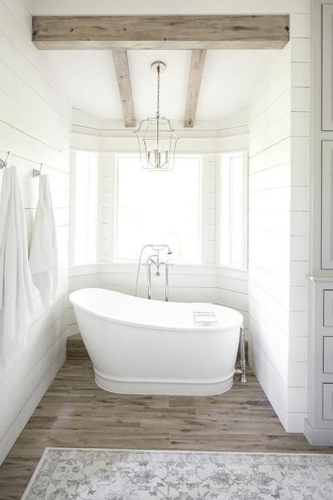 Farmhouse Bathroom: Bathtub Alcove with Rustic Wood Ceiling Beams, Positioned Beneath Bay Windows. Tub Alcove, Laundry Layout, Affordable Bathroom Remodel, Rustic Bathroom Lighting, Bathroom Beautiful, Farmhouse Bathroom Remodel, Guest Bathroom Remodel, Pony Wall, Sinks Bathroom