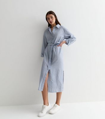 New Look Blue Stripe Poplin Long Sleeve Belted Midi Shirt Dress. Designed in a poplin fabric with split hems, this blue shirt dress is a breezy pick on warm-weather days.- Blue- Stripe print- Collared neckline- Long sleeves- Belted waist- Split hem- Midi length- Button-up fastening- Poplin fabric-Model is 5'8"/173cm and wears UK 10/EU 38/US 6 Blue Shirt Dress, Denim Gift, Midi Shirt Dress, Petite Maternity, Split Hem, Poplin Fabric, Trouser Jeans, Swimwear Accessories, Blue Shirt