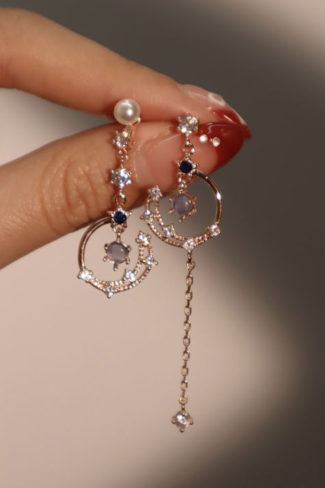 Our 18K Rose Gold Plated Moonlight Dangle Earrings are ethereal. This pair of earrings is adorned with high quality zirconia diamonds that sparkle and shine angelically. When you can’t decide on a look, match these earrings with your outfit to be your saving grace! Ethereal Jewelry, Fancy Accessories, Earrings Outfit, Aesthetic Earrings, Pretty Jewelry Necklaces, Fancy Jewellery Designs, Saving Grace, Magical Jewelry, Jewelry Accessories Ideas