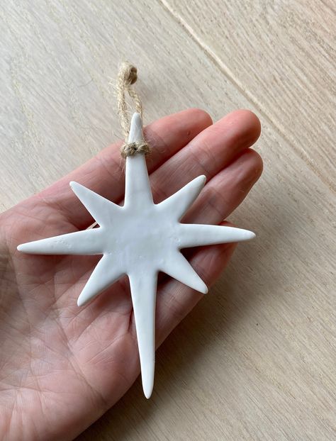 White Nordic Star Christmas Ornaments. Simple and Stylish Christmas Decorations. White Polymer Clay Stars ready to hang with twine. Your ornaments will arrive securely wrapped, packaged in a purpose recyclable box, ready to be given as a gift. Handmade in Somerset Love Scandi Style? https://www.etsy.com/uk/listing/1080251227/set-of-3-large-white-clay-stars-tree?ref=shop_home_active_4&frs=1&crt=1 https://www.etsy.com/uk/listing/1071723650/scandi-christmas-clay-stags-head?ref=shop_home_act Scandi Christmas Ornaments, Clay Diy Decoration, Christmas Home Made Gift, Ceramic Hanging Decorations, Best Christmas Ornaments, Scandi Holiday Decor, Air Dry Clay Christmas Tree Ornaments, Scandi Christmas Tree Decorations, Polymer Ornaments Christmas