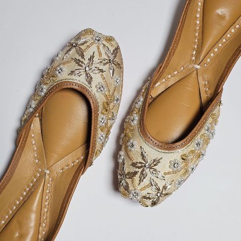 Elevate your ensemble with these exquisite Golden beige Punjabi juttis, meticulously embellished with stones and dabka work. Crafted with care, their soft padded base ensures comfort while their intricate detailing adds an elegant touch to any outfit. Step into tradition with every stride. . . . . #fancyfabjewels #jutticollection #juttiforwomen #jutti #juttis #juttilover #punjabijuttis #punjabijutti #weddingshoes #punjabijuttiyan😍 #indianbrides #indianjewelleryuk #trending #ootd #explorepage ... Dabka Work, Punjabi Jutti, Ear Chain, Jhumki Earrings, Bangles Indian, Gold Plated Bangles, Head Chain, Pakistani Jewelry, Choker Necklace Set