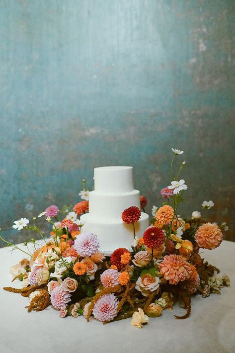 Bright Flower Wedding Cake, Fall Floral Wedding Cake, Flowers Around Wedding Cake, Muted Colorful Wedding, Bright Fall Wedding Flowers, Flowers Around Cake, August Wedding Ideas, Fall Elegant Wedding, Cake Table Flowers