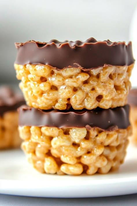 If you're a fan of peanut butter cups or the classic duo of chocolate and peanut butter, you're in for a treat with these Chocolate Peanut Butter Rice Krispie Cups! They're the ideal indulgence to satisfy your sweet cravings. Get ready to enjoy crafting a snack that's as enjoyable to make as it is to Chocolate Peanut Butter Crunch Cups, Peanut Butter Rice Krispie Cups, Rice Krispie Peanut Butter Chocolate, Chocolate Peanut Butter Rice Crispy Balls, Rice Krispie Peanut Butter Treats, Turkey Leg Rice Krispie Treats, Peanut Butter Balls With Rice Krispies, Peanut Butter Rice Crispy Balls, Peanutbutter Ricekrispies