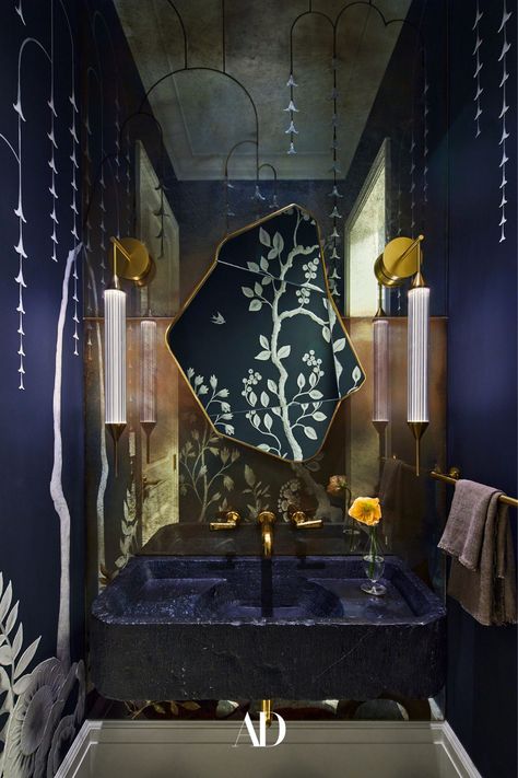 In a powder room of actor and entrepreneur Gwyneth Paltrow's home, hand-painted wallpaper and a mirror by MJ Atelier, sconces by Giopato & Coombes through StudioTwentySeven, and an antique marble sink from Stone Objects with THG fixtures all given the smaller space a moodier and regal feel. #bathroom #powderroom #sink #sconces #sink #faucets #bathroommirror #vanity #wallpaper #towels #mirroredwall #moodystyle #decor #lightingfixtures #towelholder #flowers #art #painting #bathroomwallpaper Lindsey Adelman Lighting, Grey Water System, Colin King, John Baldessari, Roman And Williams, Scenic Wallpaper, Hand Painted Wallpaper, New York Apartment, Up House