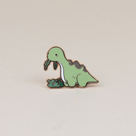 Who can resist that cute face? Not even the fussiest of eaters will be able to turn down their veggies when they see this adorable Bronti enamel pin. It's the perfect way to show your love for all things green! Size: 1.2" x 1.6" Dino Stickers, Dinosaur Pin, All Things Green, Enamel Pin Collection, Backpack Pins, Jacket Pins, Pretty Pins, Cute Face, Cool Pins