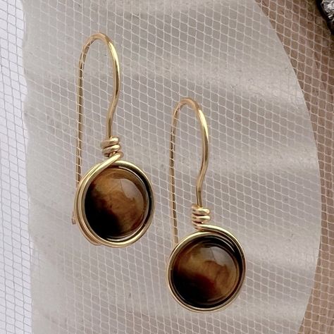 Tigers Eye Gold Wire Wrapped Earrings Minimalist Drop Earrings Are A Wardrobe Essential 8mm Smooth Round Tiger Eye Beads Overall Length 1” Tarnish Resistant 20 Gauge Gold Plated Copper Wire Also Available In 14k Gold Filled Wire For An Additional Price Gorgeous Simplicity Perfect For Every Day Wear, Will Go With Everythingcareer Business Or Casual Tiger Eye Is The Birthstone Of Gemini A Unique Characteristic Of The Tiger A Gemstone Is It No Two Are Alike Due To The Natural Banding Tiger’s Eye Is Gold Wire Wrapped Earrings, Stocking Stuffers For Mom, Glass Drop Earrings, Wrapped Earrings, Art Earrings, Tiger Eye Beads, Eye Beads, Jewelry Studio, Wire Wrapped Earrings