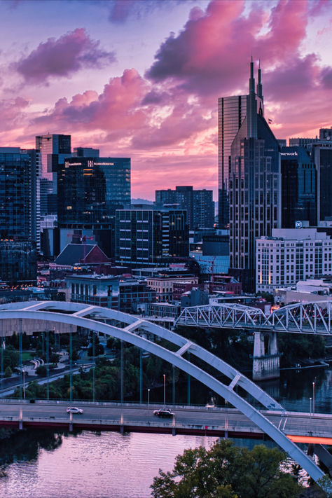 Skyline of Nashville shot from across the river as the sun sets and the sky in pink and full of clouds. Nashville Tennessee Aesthetic, Nashville Aesthetic, Tennessee Aesthetic, Nashville City, Music City Nashville, Nashville Music, Luxury Collection Hotels, Nashville Trip, Solo Trip