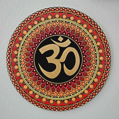 This OM symbol mandala art piece measures, - 12 inches in diameter  - 0.5 inches thickness. There is a hook attached behind for easy hanging. Made with acrylics and sealed with permanent sealant to protect colors. Please reach out for any questions/customization. Om Painting Om Symbol, Om Mandala Art, Easy Mandala Art, Om Symbol Art, Om Mandala, Pooja Decor, Mandala Wall Hanging, Background Diy, Om Symbol