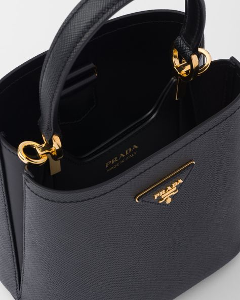 Leather handle Detachable and adjustable 105 cm leather shoulder strap Removable leather name tag Metal hardware Metal lettering logo on a leather triangle at the front Magnet closure Nappa leather lining with center pocket Small feet on the bottom Prada Black Shoulder Bag, Small Designer Handbags, Designer Handbags 2024, 2024 Designer Bags, Prada Black Bag, Luxury Crossbody Bag, Prada Mini, Metal Lettering, Prada Tote Bag