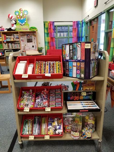 School supply display on cart Dinosaur Themed Scholastic Book Fair Elementary Classroom Nostalgia, Pbis School Store, Book Fair Set Up, Book Fair Display Ideas, School Store Display Ideas, School Book Fair Ideas, Bible Bucks Store Ideas, Book Fair Theme Ideas, School Store Ideas Elementary