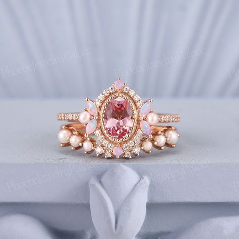 Vintage Oval Pink Sapphire Engagement Ring Set Unique Pearl Opal Cluster Pinky Wedding Rings for Women Anniversary Gift for Her Personalized PRODUCT SUMMARY Metal Type: yellow, white or rose solid 10k, 14K or 18k gold. Size: All sizes are available, contact me if they do not contain the size you want in the drop-down menu. ☪☪Engagement ring ⚜Center Stone - Lab Grown Peach Pink Sapphire Cut - Oval Size - 5x7mm ⚜Side Stone - Natural Pinky Opal & Moissanite Cut - Round & Marquise cut Weight -0.396c Pink Pearl Wedding Ring, Pink Sapphire Rings, Engagement Rings Colorful, Engagement Rings With Color, Wedding Rings Colored Stones, Pink Wedding Rings Sets, Kunzite Engagement Ring, Unique Rings Engagement, Whimsical Wedding Ring