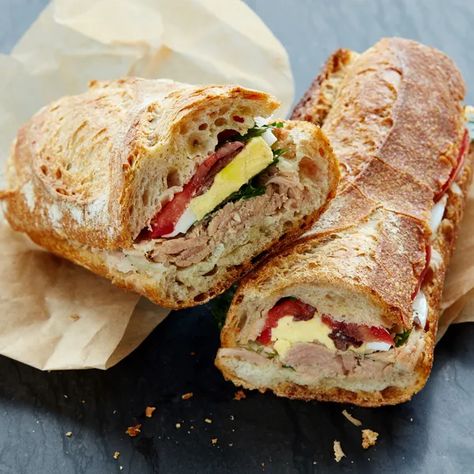 When you think about it, "Pan Bagnat" is just a fancy way of saying "the best of all possible summer sandwiches." Unlike the typical tuna on wheat, this Provençal classic only gets better as sits, making it just the thing for picnics, backyard suppers, and last-minute road trips. And its briny, garlicky flavors beat plain old mayo any day. Anchovy Recipes, Seafood Sandwiches, Pan Bagnat, Canned Tuna Recipes, Parsley Recipes, Picnic Sandwiches, Summer Sandwiches, 100 Calorie, Tuna Recipes