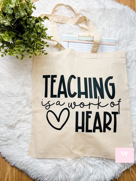 "Teaching Is A Work Of The Heart Tote| Teacher Tote Bag| Gift for Teacher| Teacher Appreciation| Teacher Bag| Gift for Her| Teacher Name Tote Personalization is optional and free! - Made 100% cotton - Measurements 15 W x 16 H - Handles sized 1\" W x 25\" L I gladly accept cancellations Request a cancellation: must be within 1 hour of purchase * I don't accept returns or exchanges. Please feel free to contact me if you have any problem with your order. Thank you, for supporting my small business! Cricut Canvas Tote Bag Ideas, Teacher Gift Personalized, Teachers Personalized Gifts, Teacher Appreciation Bags, Teacher Appreciation Tote Bags, Diy Teacher Tote Bag, Back To School Tote Bags, Teaching Is A Work Of Heart, Teacher Bag Ideas