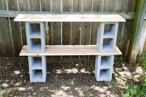 This is such a simple project, and it's actually kind of a classic from 80's college dorms, but if you plop some plants on it, suddenly it looks a lot more chic and fits right into your backyard! I love these shelves to hold flowers, herbs, and gardening tools! You can see this project and more easy and affordable DIY ideas on my blog,  Love & Renovations Start by grabbing two of your cinder blocks and laying them out where you're working about 3 feet apart from one another. I highly r… Cinder Block Shelf, Cinder Block Shelves, Large Wooden Planters, Woodworking Studio, Cedar Planter Box, Planter Project, Cinder Blocks, Diy Planter Box, Plant Stands Outdoor