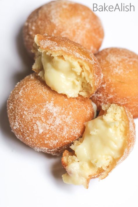 These Vanilla Custard Filled Donuts are also called Bomboloni. A soft and fluffy doughnut recipe with pastry cream filling on the inside Custard Filled Donuts Recipe, Soft Custard Rolls, Cream For Donut Filling, Bakery Doughnut Recipe, Lemon Filled Donuts Recipe, Custard Doughnut Recipe, Custard Filled Desserts, Filling For Donuts Recipes For, Creme Filled Donut Recipe