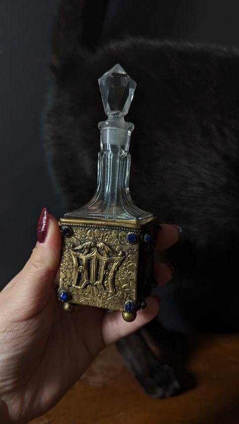 Missing two blue gems on one side Crystal bottle and stopper in perfect condition Caddy measures 1.75" square, bottle measures 4" tall Old Bottles Antique, Vintage Perfume Bottles Aesthetic, Unique Perfume Bottles, Square Bottle, Old Perfume Bottles, Crystal Bottle, Dress Rehearsal, Products Photography, Bottle Craft