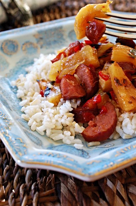 Hawaiian Sweet and Sour Smoked Sausage Recipe Cook Time: 30 minutes Difficulty: Easy How does smoky sausage, sweet tangy grilled pineapple, sweet roasted peppers, and spicy pineapple-habanero sauce sound? Does it sound like a flavor party in your mouth? You betcha! I love simple tast Pineapple Smoked Sausage, Sausage And Pineapple Recipes, Aidells Pineapple Bacon Sausage Recipes, Hawaiian Sausage Recipes, Pineapple Sausage Recipes, Smoked Sausage And Pineapple, Sausage And Pineapple, Pineapple Sausage, Smoked Sausage Recipe