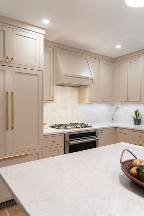 Mushroom-toned painted inset shaker cabinets with white quartz countertops and brass hardware. Mushroom Color Kitchen Cabinets, Inset Shaker Cabinets, Warm Grey Kitchen, Warm Modern Kitchen, Modern Walnut Kitchen, Greige Kitchen Cabinets, Blue Shaker Kitchen, Transitional Style Kitchen, Beige Kitchen Cabinets