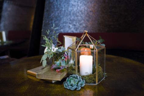 Centerpieces filled with mix of loose greenery, gold books, bud vases, lanterns and succulents. Beautiful greenery centerpiece with gold accents at MyMoon wedding venue in Brooklyn NYC. Gold and greenery centerpiece. Rosehip Social Florist. Gold and green wedding. Gold And Green Wedding, Round Table Centerpiece, Bud Vase Centerpiece, Book Centerpieces, Vase Centerpiece, Greenery Centerpiece, Lantern Centerpieces, Succulent Centerpieces, Moon Wedding