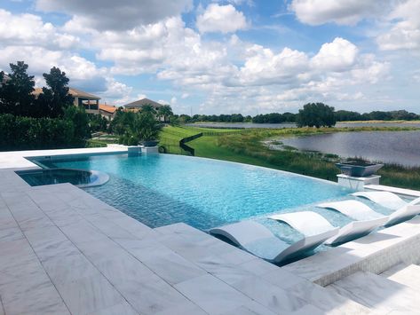 Custom infinity edge pool and spa. Infinity Pool With Tanning Ledge, Infinity Pool Sloped Yard, Infinity Edge Pool Backyards, Rectangular Infinity Pool, Faux Infinity Edge Pool, Infinity Edge Pool Design, Infinity Pools Backyard Ideas, Amazing Pools Backyard Luxury, Small Infinity Pool