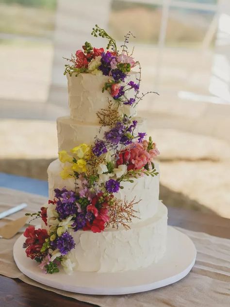 Four-tier white rustic wedding cake with cascading wildflowers Wedding Cales, Wildflower Cake, Cakes With Flowers, Wildflower Wedding Theme, Spring Wedding Cake, Small Wedding Cakes, Buttercream Wedding Cake, Wedding Cake Rustic, Rustic Wedding Cake