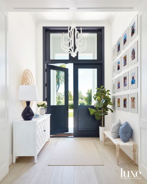 California Cool Style Comes To A Florida Home For An Active Family | Luxe Interiors + Design Coastal Entryway, Beautiful Entryways, Black Front Doors, Coastal Room, Glass Panel Door, Entrance Foyer, Foyer Design, Transom Windows, California Cool