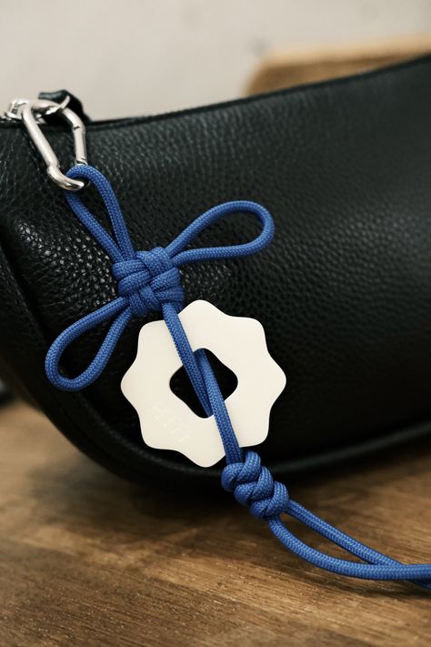 Introducing our Ama Talisman bag charm, a beautifully simplistic knotted charm designed to bring you good fortune. Engraved with our logo 'coin', this charm could be the perfect addition to your favorite bags or can be used to decorate your sacred spaces. Crafted with high-quality materials, this talisman is not only stylish but also serves as a symbol of positivity and good luck. Whether you're looking to elevate your accessories or infuse your surroundings with positive energy, the Ama Talisma Logo Design Accessories, Keychain On Bag, Cute Bag Charms, Bag Accessories Keychain, Bags Keychain, Bag Charms Diy, Diy Bag Charm, Purse Charms Diy, Goods Design