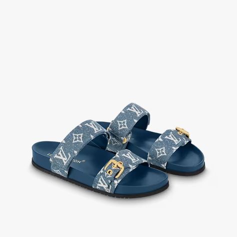 An ever-present in the Louis Vuitton shoe collection, the Bom Dia flat comfort mule is revisited in Monogram denim for a relaxed yet elegant look. This model features two adjustable straps: one with velcro and one with an engraved, gold-tone buckle. An anatomic insole and rubber outsole make this sandal extremely pleasant to wear. Louis Vuitton Slides Women, Louis Vuitton Slippers, Louis Vuitton Slides, Feminine Sandals, Louis Vuitton Heels, Fashion Shoes Heels, Cute Shoes Heels, Fashion Slippers, Girly Shoes