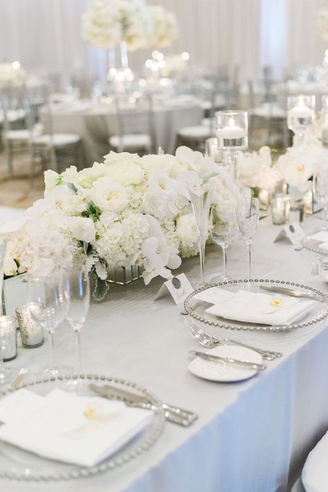 White And Grey Wedding Flowers, White Cream Ivory Wedding, Wedding Place Setting Silver, Pure White Wedding Decor, White Grey Wedding Decor, White Low Centerpiece Wedding, White And Silver Table Settings, White Wedding Set Up, Black White And Silver Wedding Reception