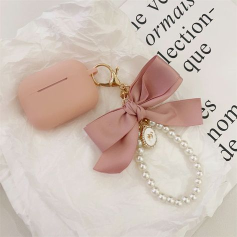 Add a touch of charm to your AirPods with our Pearls and Pink Bow AirPods Case. This therapeutic-style case features a soothing pink bow, perfect for AirPods Pro, AirPods 3, and the 2nd and 3rd generations of AirPods. The case's soft-shell design ensures your earbuds are protected in a delicate yet secure manner. The gentle pink bow, coupled with elegant pearls, offers a sweet and stylish look. This case is not just about protection; it��’s a fashion statement that reflects a soft, calming aesthet Aesthetic Airpods Case, Airpods Case Aesthetic, Aesthetic Airpods, Airpods 3, Shell Design, Fancy Bags, Aesthetic Ideas, Smart Living, Daily Routines