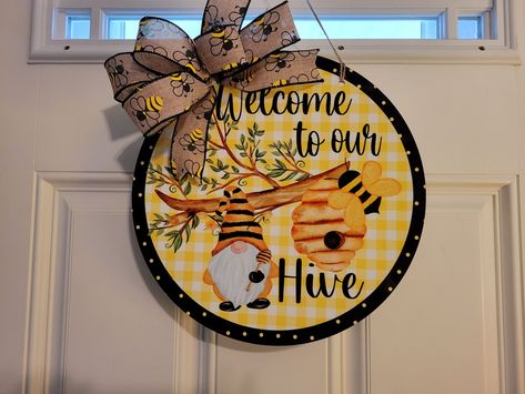 "\"Welcome to Our Hive\" Bee Themed Door Hanger These are perfect to give as a housewarming gift or to anyone for any occasion Each door hanger is made of MDF and measures 12.25 inches round.  Jute rope is added for hanging.   Add a bow for maximum style.  Your bow may Vary due to stock. It is printed with a dye sublimation process that is UV resistant and will last for many years.  It is recommended that you hang on a covered porch or patio to prevent moisture damage." Bumblebee Decor, Bees Hive, Welcome To Our Hive, Happy Valentines Day Sign, Bumble Bee Craft, Bee Gnome, Bee Sign, Honey Bee Decor, Gnome Decor