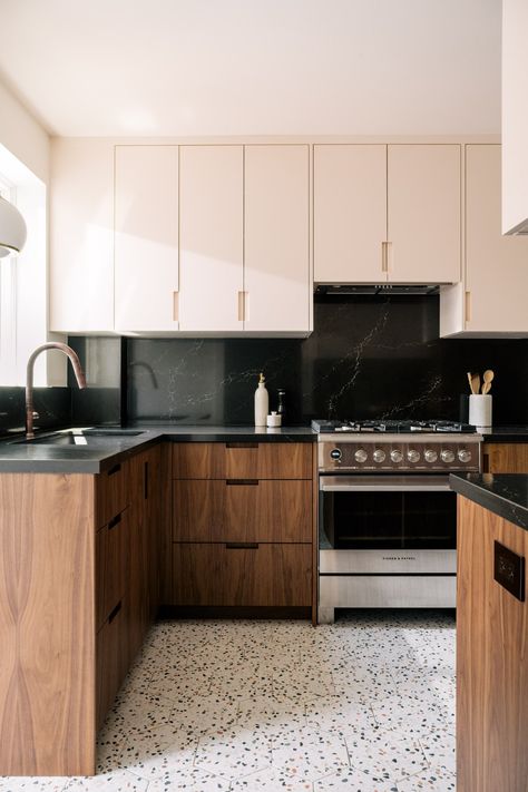 A narrow galley kitchen with blush pink upper cabinet and ceiling, black countertops, and brown lower cabinets. The floor is filled with a hexagonal terrazzo tile. Galley Kitchen With Black Countertops, Terrazzo Mid Century, Terrazzo Island Kitchen, Kitchen Diner Flooring Ideas, Two Tone Galley Kitchen, Terrazo Kitchen Flooring, Terrazo Kitchen Floor, Terrazzo Tile Kitchen Floor, Kitchen Tile Flooring Ideas