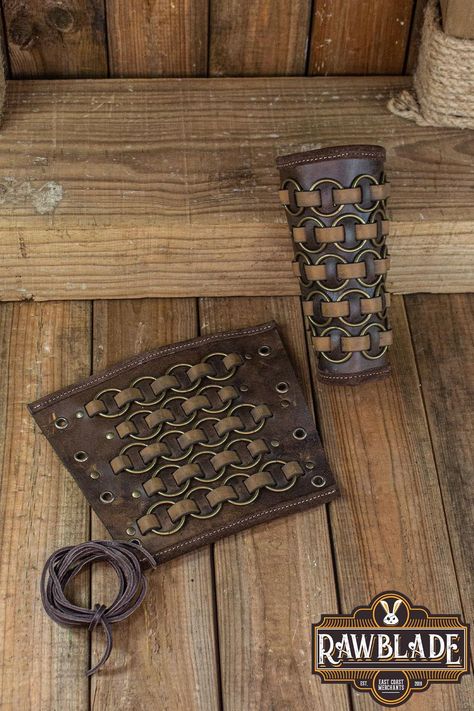 Introducing our Fighter Bracers, a formidable pair of leather armguards that exude the spirit of the medieval warrior. These bracers, adorned with metal rings intricately woven into leather strips, offer both protection and style, making them an essential accessory for LARP, historical reenactment, rennaisance fairs, and medieval events. Part of our esteemed Fighter product series, these bracers are meticulously crafted from high-quality leather, ensuring durability and reliability on the battle Armor Craft, Viking Cosplay, Arm Guards, Medieval Aesthetic, Historical Reenactment, Leather Armor, Leather Projects, Fantasy Clothing, Diy Creative